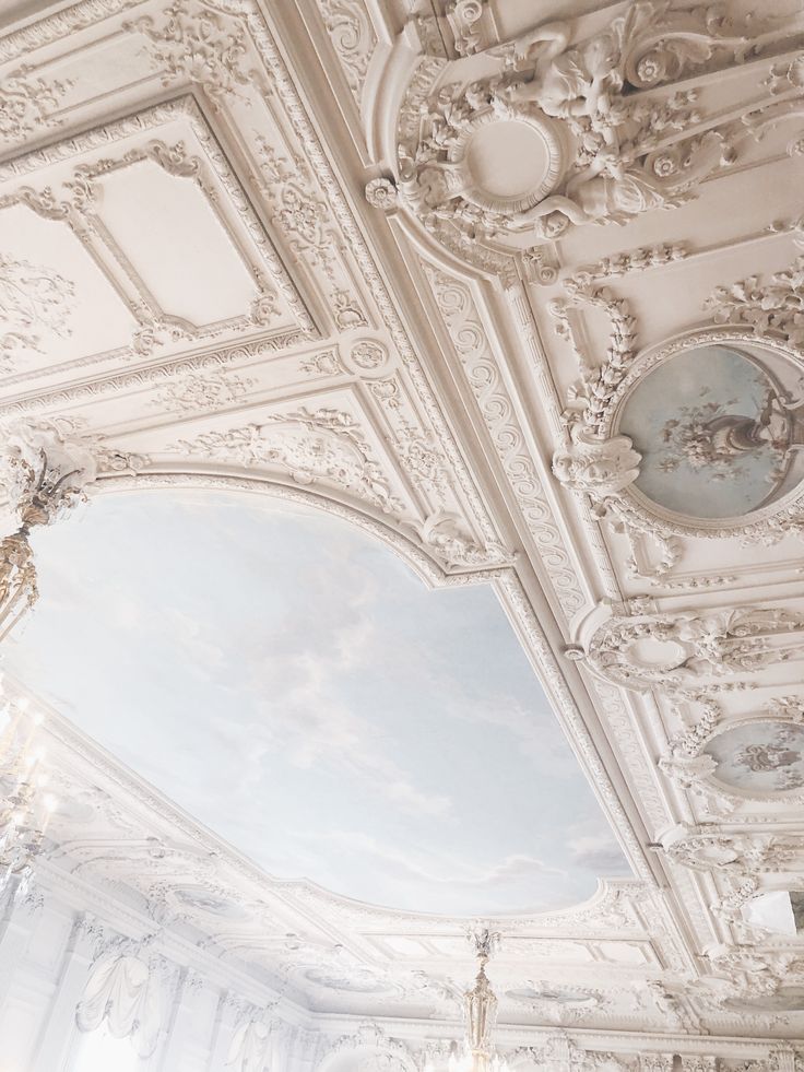 an ornately decorated room with chandeliers and paintings on the ceiling is shown