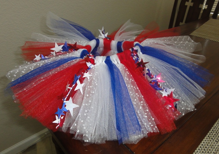 a red, white and blue tutu skirt sitting on top of a wooden table