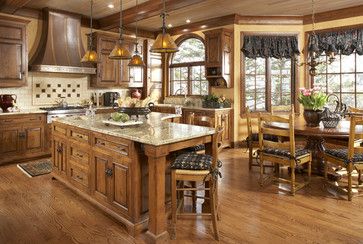 a large kitchen with wooden floors and lots of counter space, including an island in the center