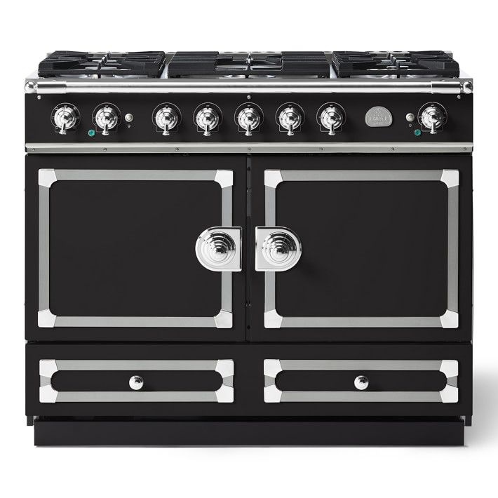 a black stove top oven sitting on top of a white countertop with two burners