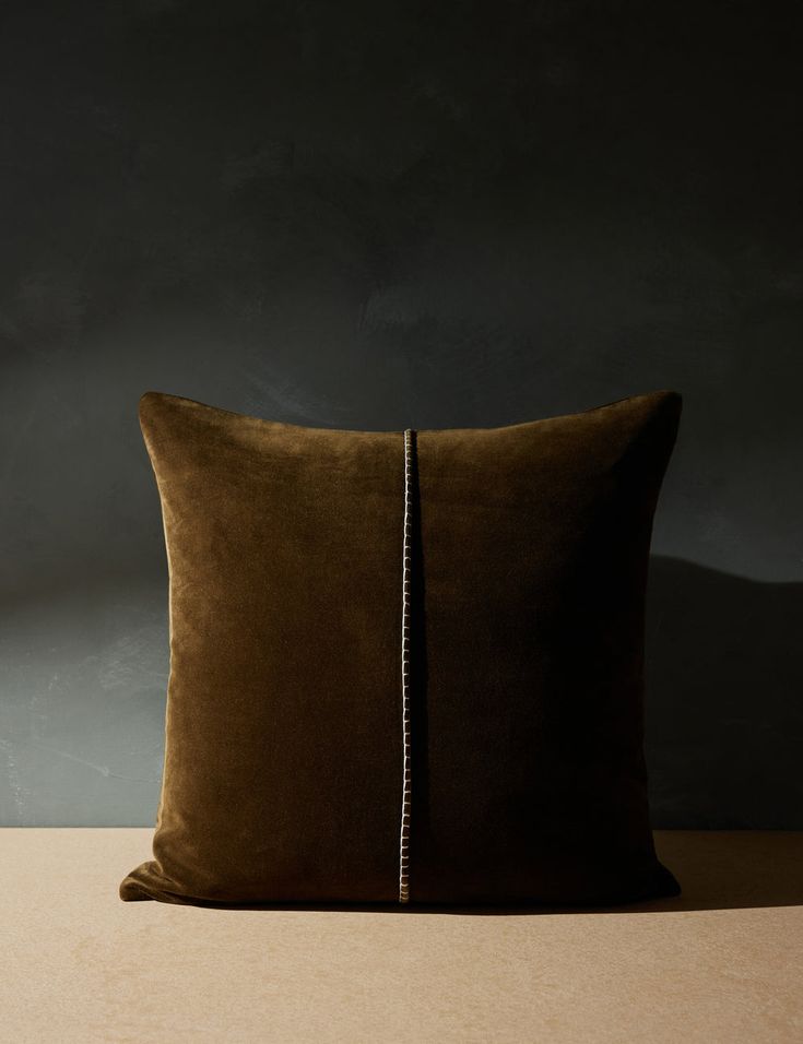 a brown pillow sitting on top of a wooden table