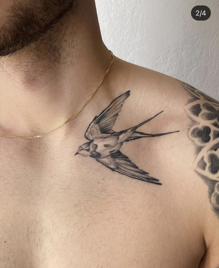 a man with a bird tattoo on his chest