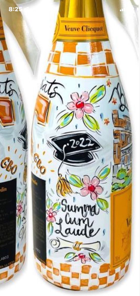 two wine bottles painted with graduation caps and flowers, one is orange and the other is white