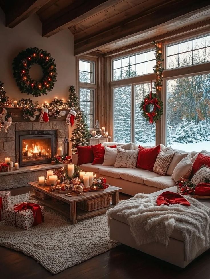 a living room decorated for christmas with candles and presents on the fireplace mantels