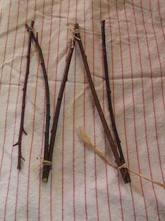 three sticks that have been tied together on a sheet