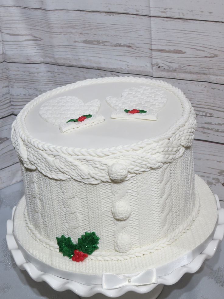 a white cake decorated with holly and buttons