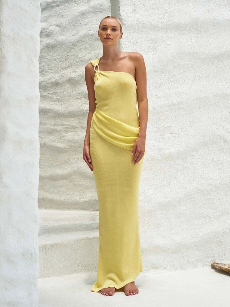 The "Lyn Dress" in Carambolo - A one-shoulder knitted dress featuring a striking baobab shape detail at the shoulder, complemented by pleated detailing at the front. With an asymmetric cut at the bottom and a vibrant yellow tone, this dress is sure to make a statement. With this purchase, you are supporting the rehabilitation of the coral reef in San Andrés Island, Colombia, in alliance with Corales de Paz Organization.
 Size: XS, S, M, L Yellow Off-shoulder Maxi Dress For Party, Chic Yellow Off-shoulder Maxi Dress, Yellow One-shoulder Fitted Maxi Dress, Yellow One-shoulder Evening Midi Dress, Yellow One-shoulder Midi Dress For Evening, Yellow Fitted One-shoulder Maxi Dress, Yellow Fitted One-shoulder Dress, Elegant Yellow Asymmetrical Maxi Dress, Fitted Yellow One-shoulder Dress