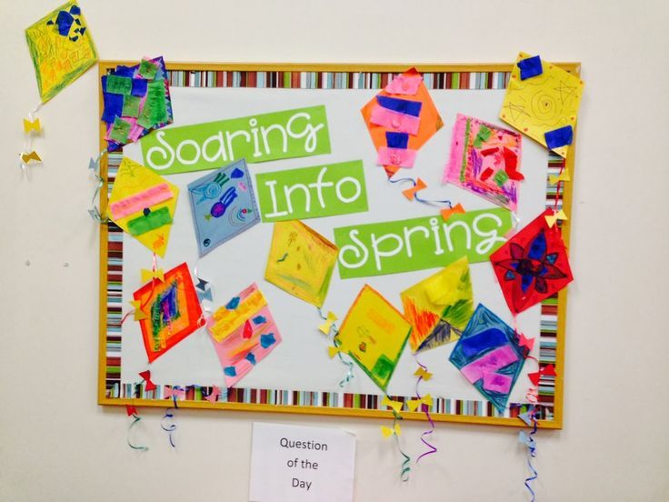 a bulletin board that has been decorated with colorful papers and streamers on the wall