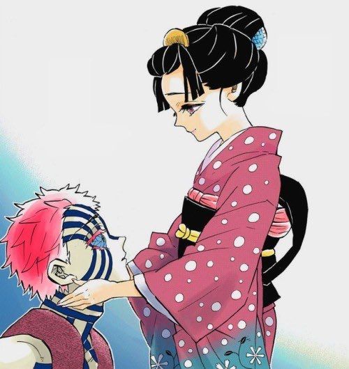 a woman in a pink and white polka dot kimono is petting a cat