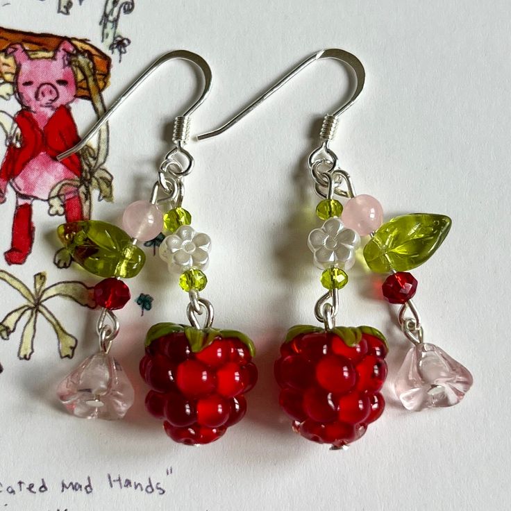 Handmade raspberry earrings. Crafted with meticulous care, each pair showcases the essence of summer in wearable art. These artisan earrings are perfect for fruit enthusiasts and nature lovers alike, adding a pop of color and whimsy to any outfit. Whether you're strolling through a farmer's market or attending a garden party, these unique earrings are sure to make a statement. Elevate your style with a touch of berry bliss and embrace the beauty of handmade craftsmanship.  Weight: They are light Valery Core Earrings, Summer Fruit Earrings, Summer Flower Sterling Silver Earrings For Gift, Summer Flower Earrings In Sterling Silver For Gift, Sterling Silver Flower Earrings For Summer, Sterling Silver Flower Earrings For Summer Gift, Whimsical Red Drop Earrings, Whimsical Red Jewelry With Matching Earrings, Whimsical Handmade Red Earrings