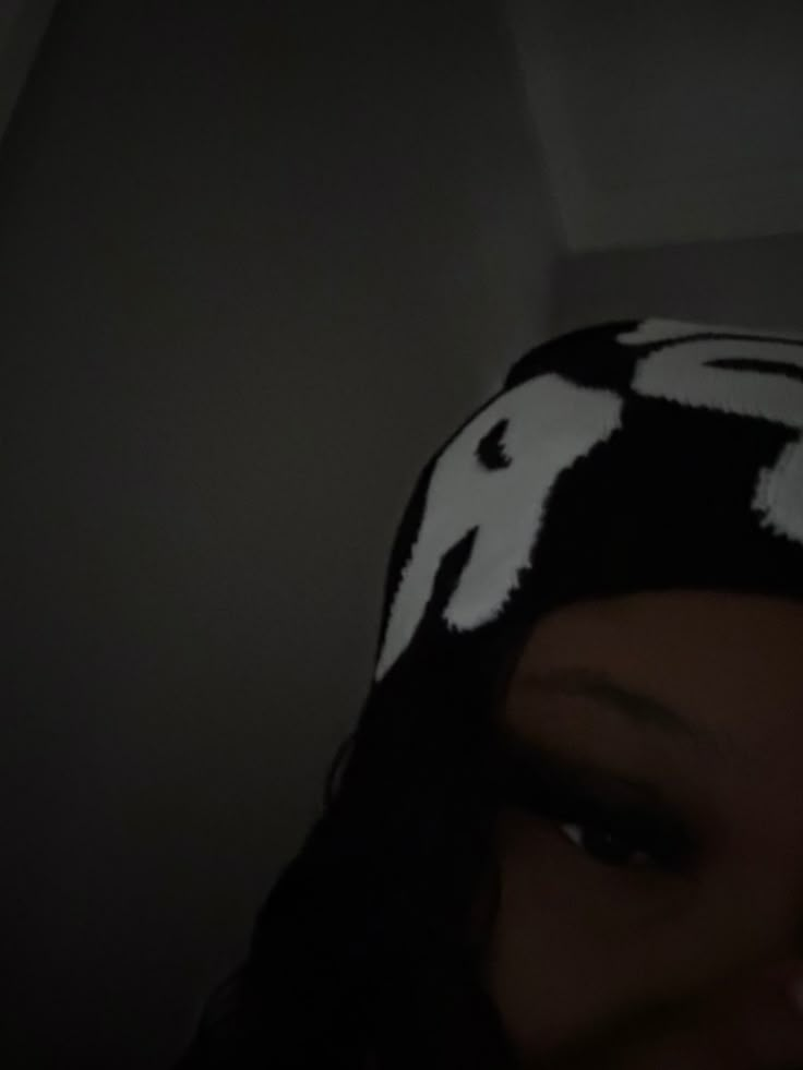 a close up of a person wearing a hat with an animal print on it's head