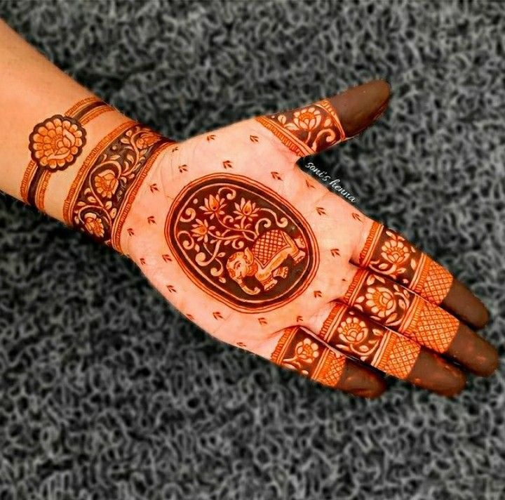 a woman's hand decorated with hennap and intricate designs on her hands