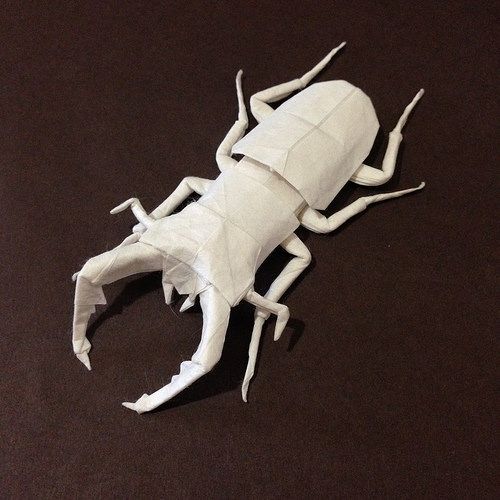 an origami scorpion is sitting on the floor