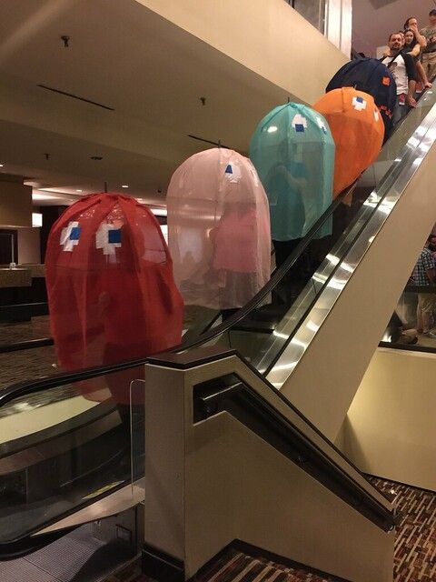 people riding an escalator with hats on them