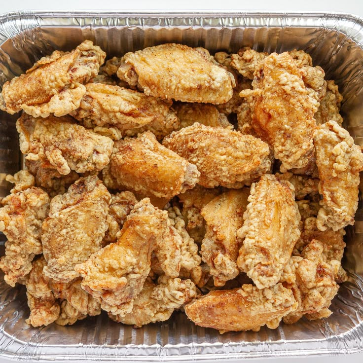 fried chicken in a metal pan on a table