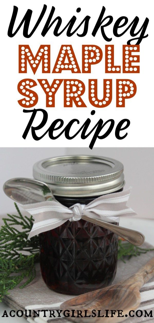 a glass jar filled with maple syrup sitting on top of a table