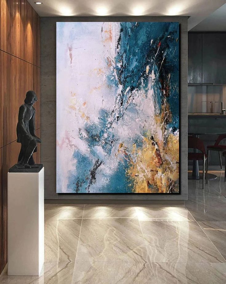 an abstract painting hangs on the wall next to a marble pedestal in front of a dining room table