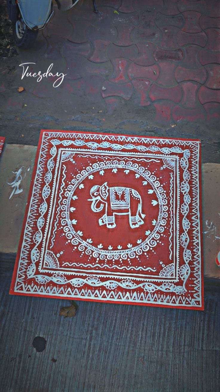 a red and white rug with an elephant on it