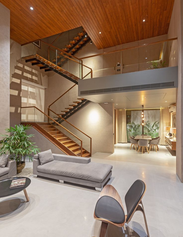 a living room filled with furniture and a stair case