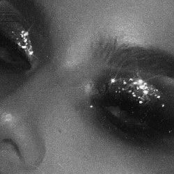 black and white photograph of woman's eyes with glitter on them