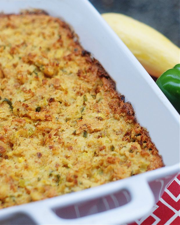 a casserole dish with broccoli and green peppers in the back ground