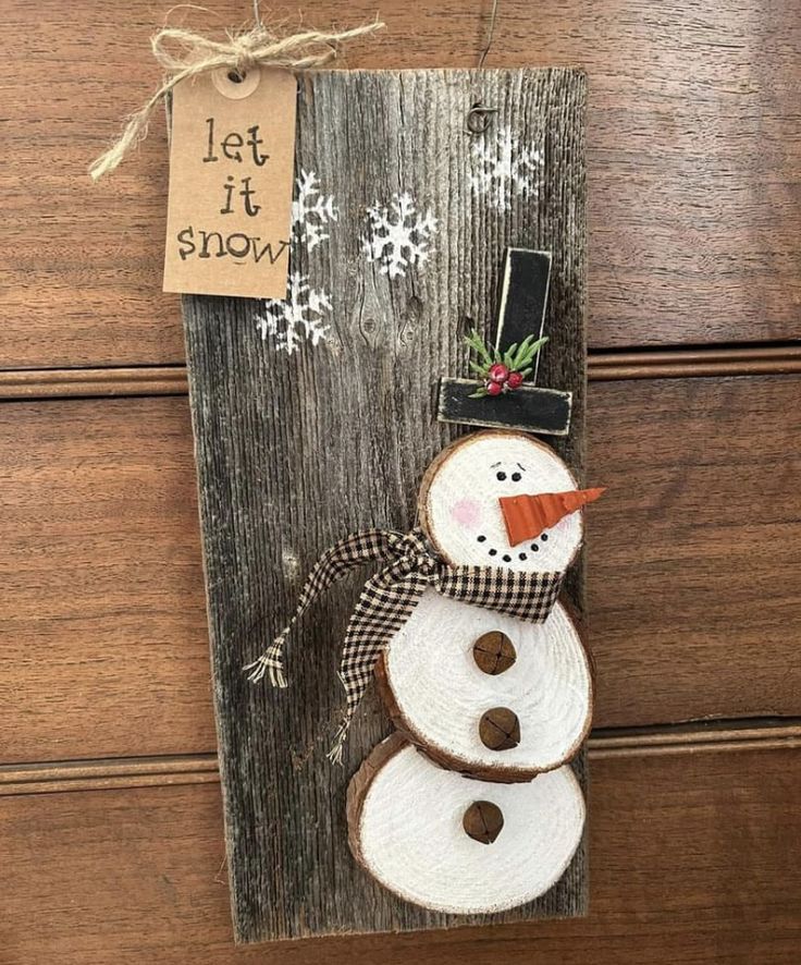 a wooden sign with a snowman on it