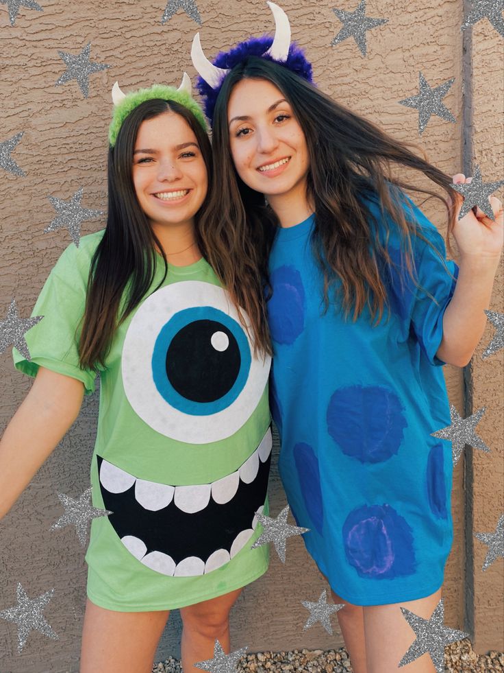 two girls dressed up as monsters posing for the camera with their arms around each other