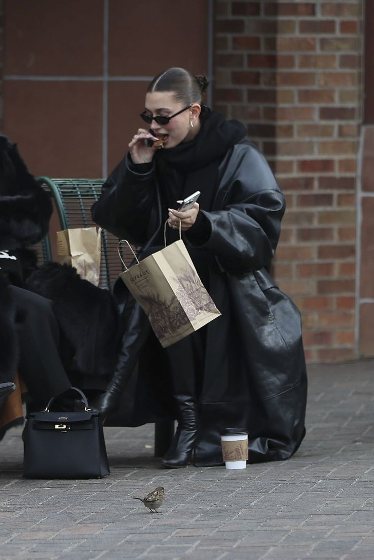 a woman talking on her cell phone while holding shopping bags