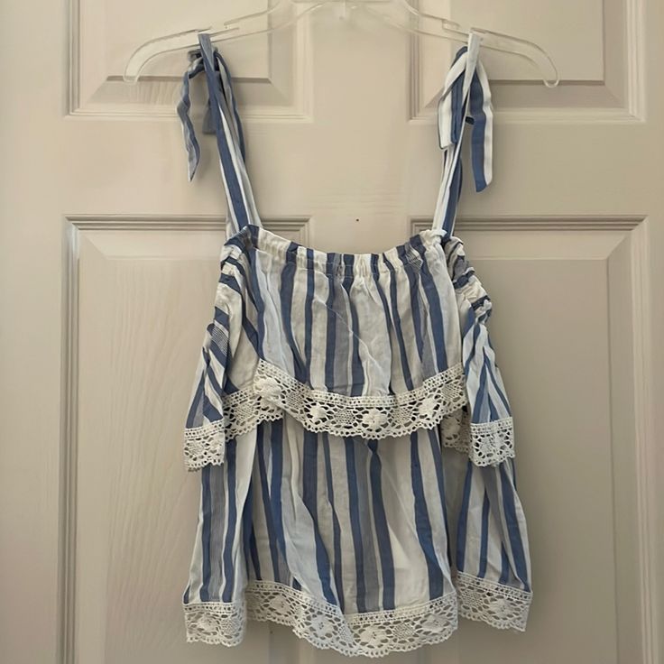 Baby Blue And White Tank Top With Ties At Shoulders. Lace On Bottom Of Each Layer. Super Cute! Cute Blue Tops For The Beach, Blue Cotton Tank Top With Ruffles, Cute Blue Tank Top For Beach, Cute Light Blue Tops For Vacation, Cute Light Blue Top For Vacation, Cute Light Blue Tops For Day Out, Cute Striped Tops For Vacation, Small Tank Tops, Draped Midi Dresses