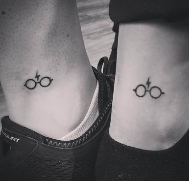 two small harry potter tattoos on both legs, one is black and the other is white