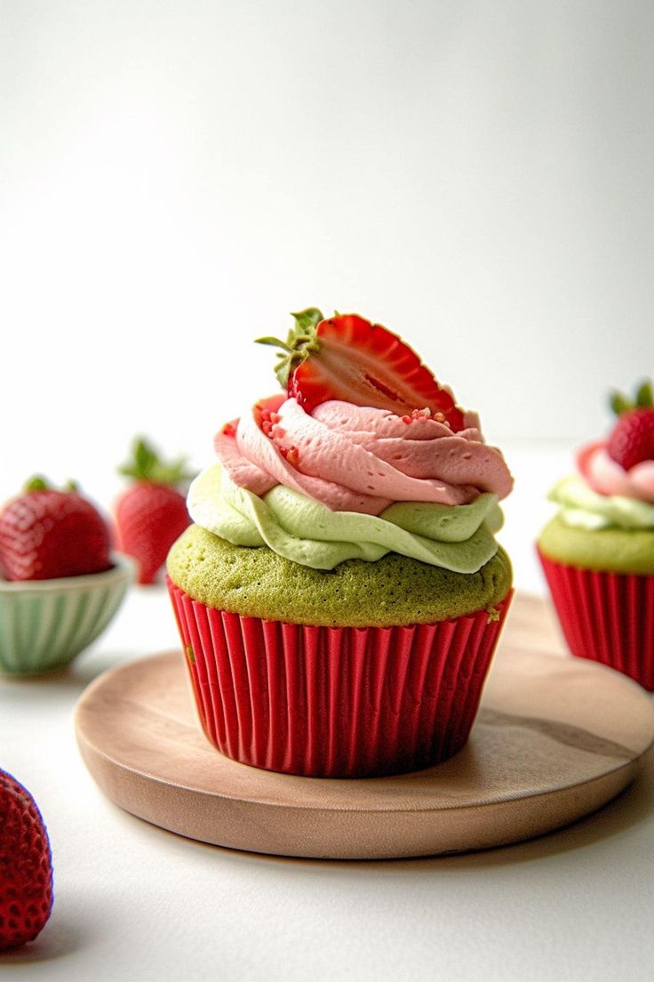 cupcakes with frosting and strawberries on top