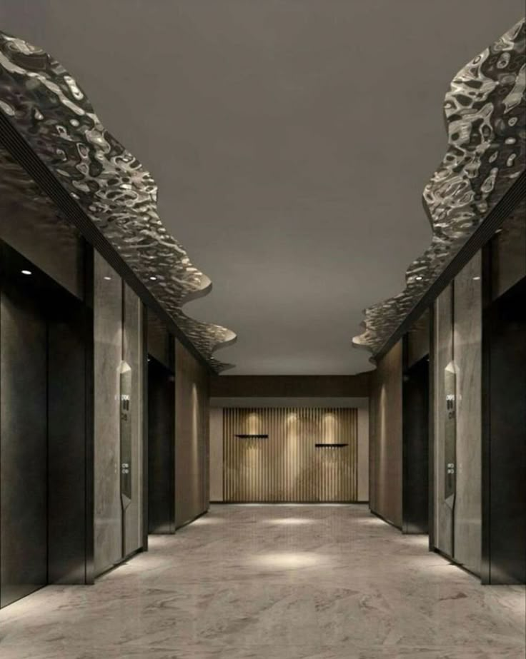 an empty hallway with several doors and lights on either side of the corridor is lit by recessed lighting