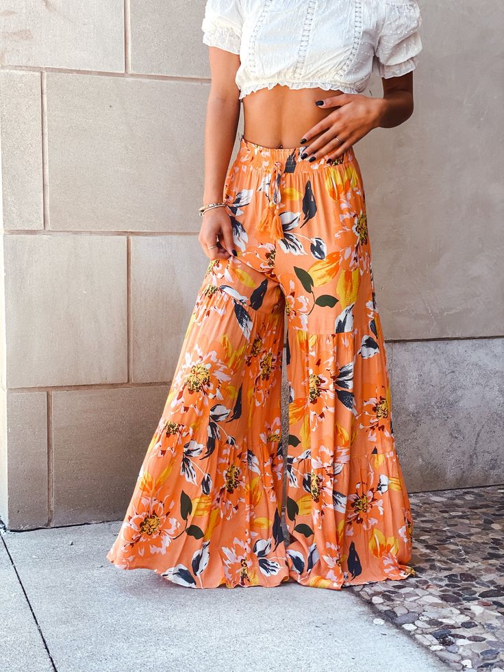 How iconic is the color and print on our Seaside Sunset Wide Leg Pants? These orange and white pants have an ultra wide leg and a flattering, smocked waist. Finished with a sewn adjustable waist tie. Spring Beach Flare Bottoms, Spring Beach Flare Pants, Beach Flare Pants For Spring, Summer Printed Bottoms For Brunch, Printed Summer Bottoms For Brunch, Casual Flared Bottoms For Vacation, Summer Orange Wide-leg Pants, Summer Vacation Flare Pants, Orange Wide-leg Summer Bottoms