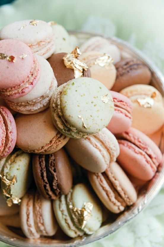 a bowl filled with lots of different colored macaroons