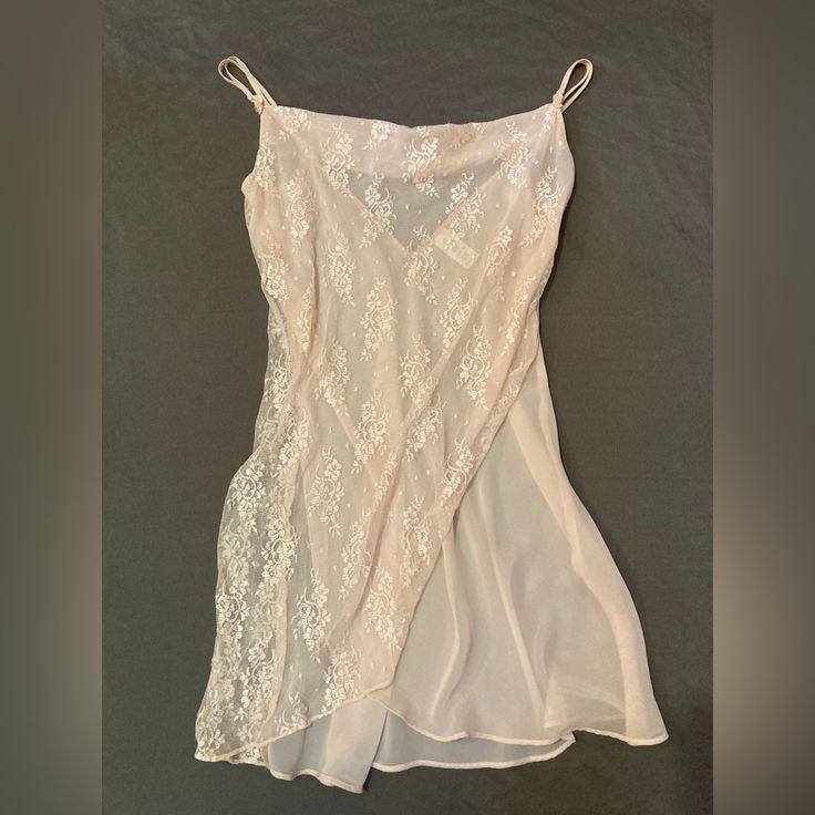 Pastel Peach Sheer Lace Nightgown/Slip In Size Large. Classically Feminine And Great Quality. Double Strapped With Tiny, Delicate Bows Where Straps Meet Gown. Straps Are Adjustable. It’s A Sheer Creamy Peach Gown With A Sheer Lace Wrapped Front In The Same Color. Has A Flattering Cowl Neckline. Bought And Never Worn. It Is In Great Condition. Sheer Fabric Is 100% Polyester While Lace Is 100% Nylon. It Is Machine Washable And Can Be Tumble Dried On Low. Please Feel Free To Message Me With Any Que Sheer Lace Slip Dress For Sleep, Spring Lace Nightgown With Spaghetti Straps, Pink Sheer Slip Dress For Summer, Feminine Spring Slip Dress For Sleepover, Pink Lace Nightgown For Summer, Summer Nightgown With Delicate Lace In Flirty Style, Spring Night Sheer Slip Dress, Sheer Night Slip Dress For Spring, Summer Nightgown With Delicate Lace In Coquette Style