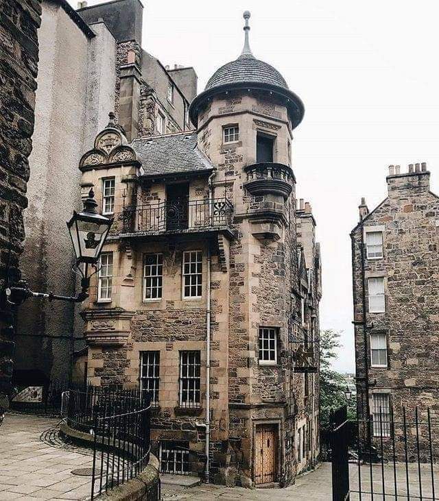 an old stone building with many windows and balconies