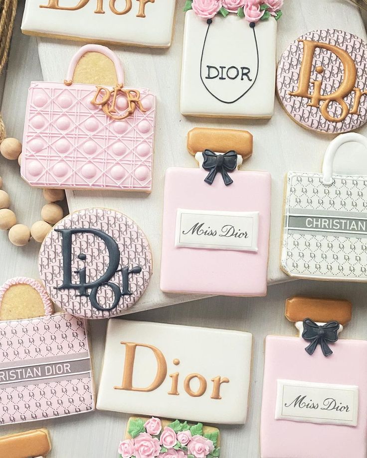 decorated cookies are arranged on a table with the words dior and purses in different languages