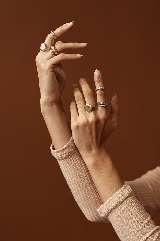 two women with their hands in the air, one holding her hand up to the other