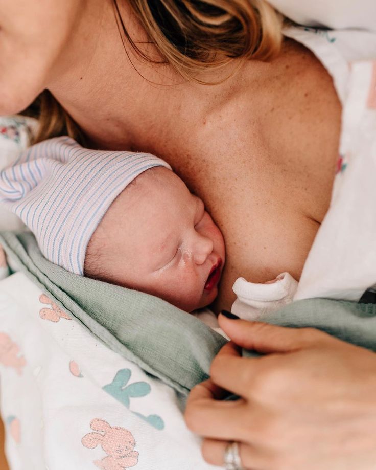 a woman holding a baby in her arms