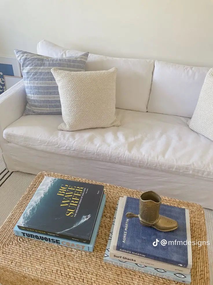 a white couch sitting next to a coffee table