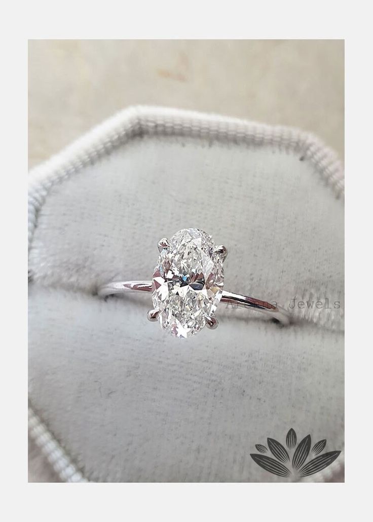 a diamond ring sitting on top of a cushion