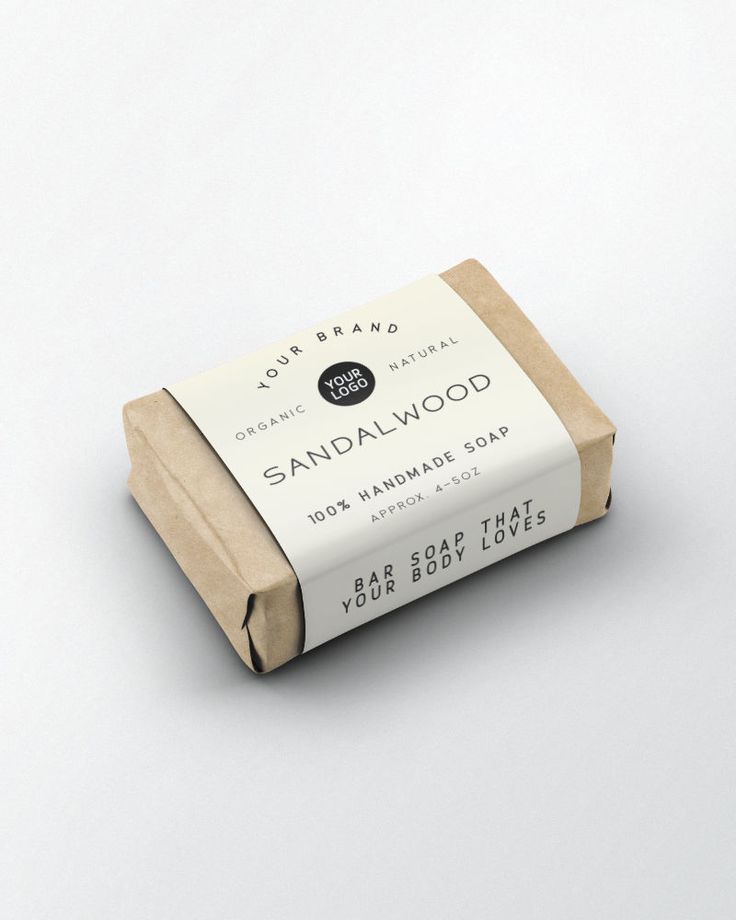 a soap bar sitting on top of a white surface next to a brown package with the label sandalwood