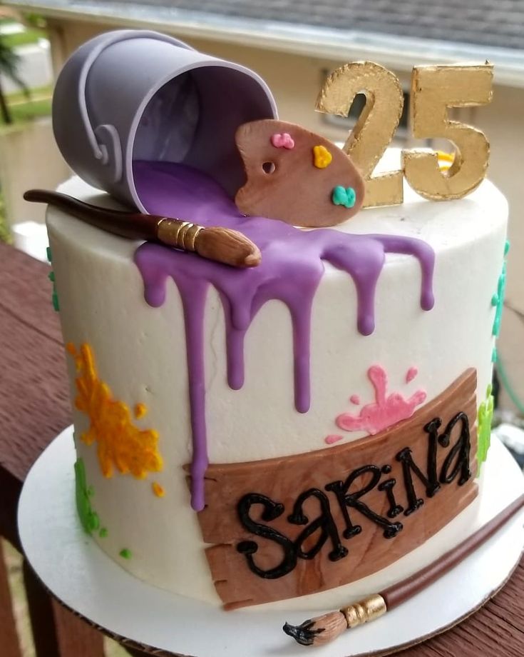 a birthday cake with purple icing and decorations on the top is for someone's 25 year old