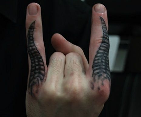 two hands with black and grey tattoos on them