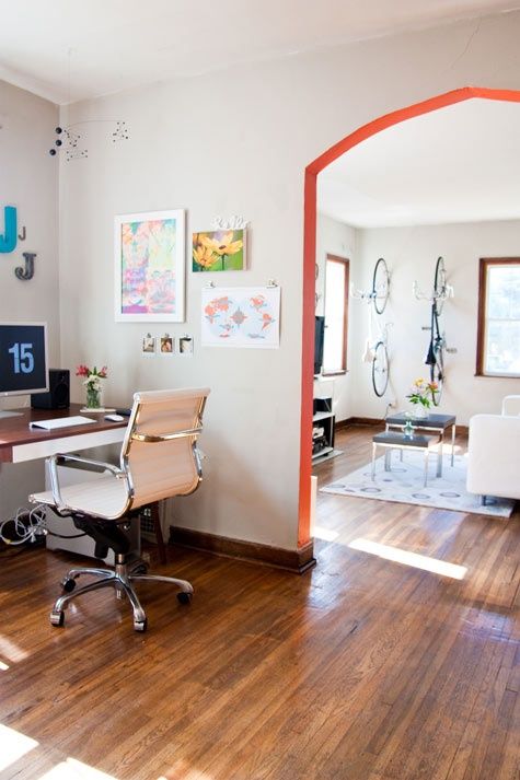 a living room filled with furniture and a flat screen tv sitting on top of a wooden floor