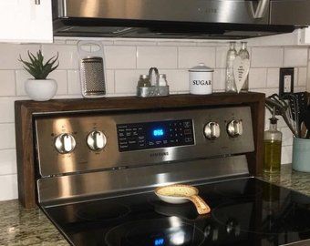 a stove top oven sitting inside of a kitchen