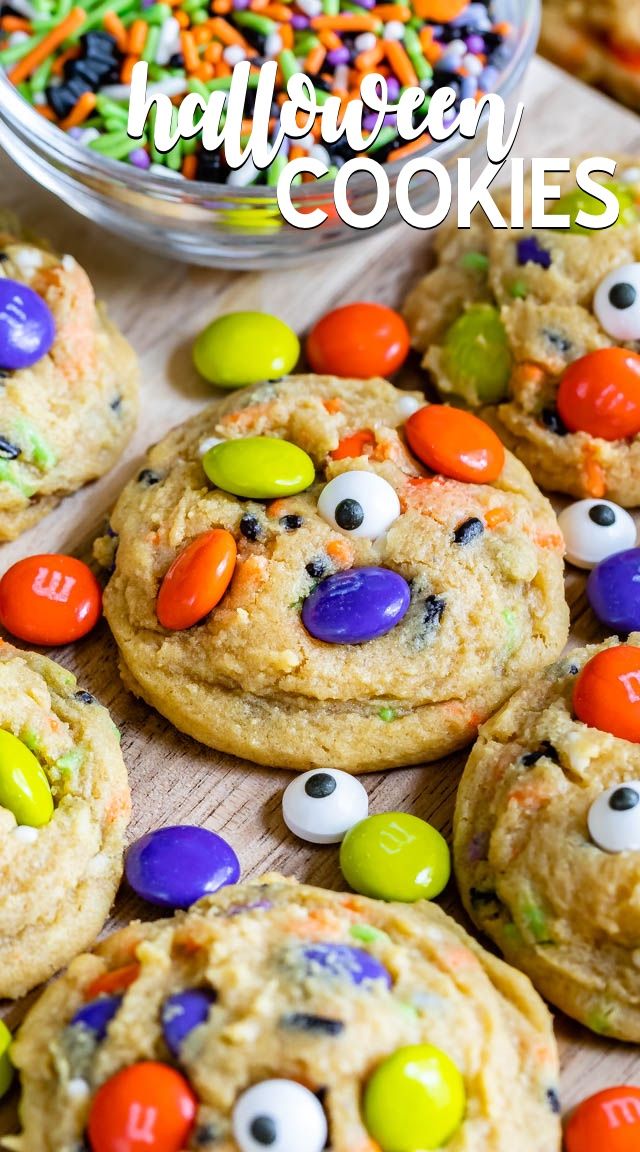 monster cookies with candy eyes and m & m candies all over them on a table