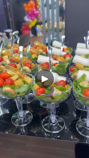 a table topped with lots of different types of food on top of glass bowls filled with fruit