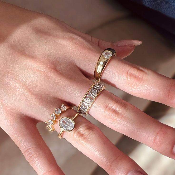 These four exquisite rings are made of S925 silver plated with 14K gold and adorned with beautiful AAA+ zirconia stones. They feature an adjustable open design, making them very convenient to wear. You can adjust the size of the ring according to your finger size to ensure comfort and fit.  They are not only suitable for daily wear, but also can be an excellent choice as a special gift for her. Whether it's a birthday gift, anniversary gift, or Valentine's Day gift, these rings will bring her surprise and joy. Whether she prefers a minimalist style or a glamorous style, these four rings can satisfy her taste and preferences. Whether paired with casual outfits or formal attire, these rings will add a touch of sparkle and detail to her overall look. Let her feel your love and thoughtfulness, Yellow Gold Cubic Zirconia Midi Rings, Everyday Diamond White Ring Jewelry, Dainty Oval Cubic Zirconia Ring, Cubic Zirconia Midi Rings With Diamond Accents, Dainty Diamond White Crystal Ring With Cubic Zirconia, Anniversary Fine Jewelry Midi Rings With Cubic Zirconia, Gold Midi Rings With Diamond Accents, Dainty Rings With Diamond Accents And Cubic Zirconia, Dainty Cubic Zirconia Rings With Diamond Accents