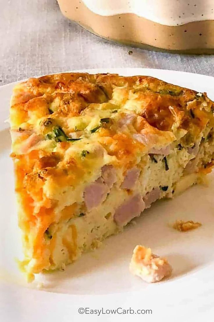 a slice of quiche on a white plate